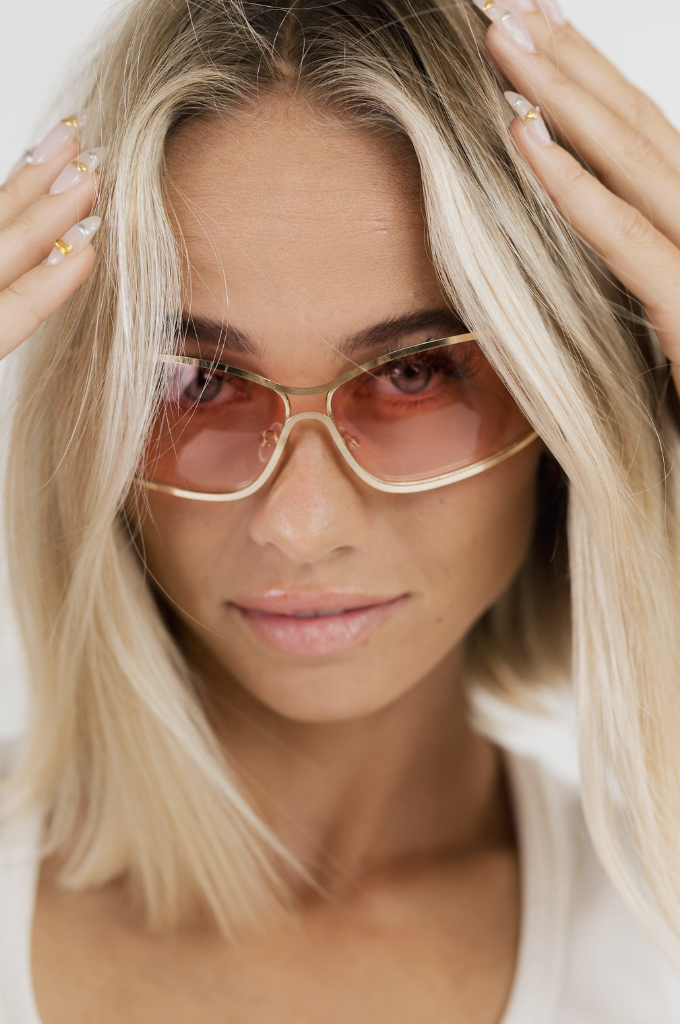 Woman wearing gold-frame sunglasses