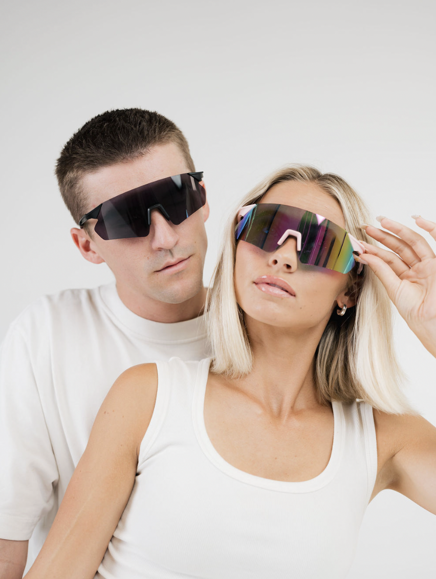 A man and woman wearing sport shield sunglasses